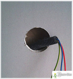 Coupe de l’excédent de gaine après perçage du logement du boîtier de prise électrique